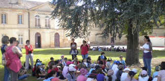 Animations extérieures pour les collégiens Des collégiens en train d'écouter une dame lors d'une animation, à l'extérieur dans un jardin