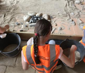 Un enfant qui découvre l'atelier module de fouilles