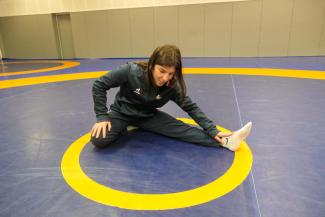 Julie Sabatié en train de s'étirer sur le tatami 